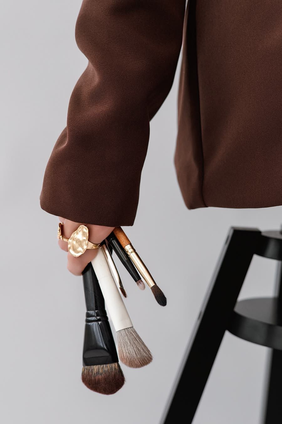 Make-up artist holding a set of professional brushes